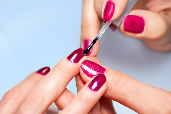 depositphotos_41535405-stock-photo-woman-applying-nail-varnish-to